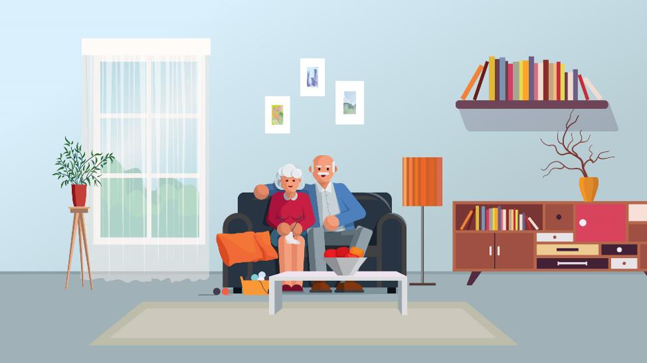 Elderly couple sitting on couch in living room with plants, books and a bookshelf.