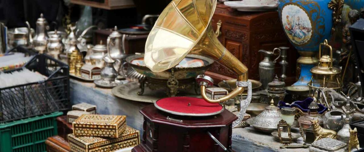 A vintage gramophone surrounded by other antiques