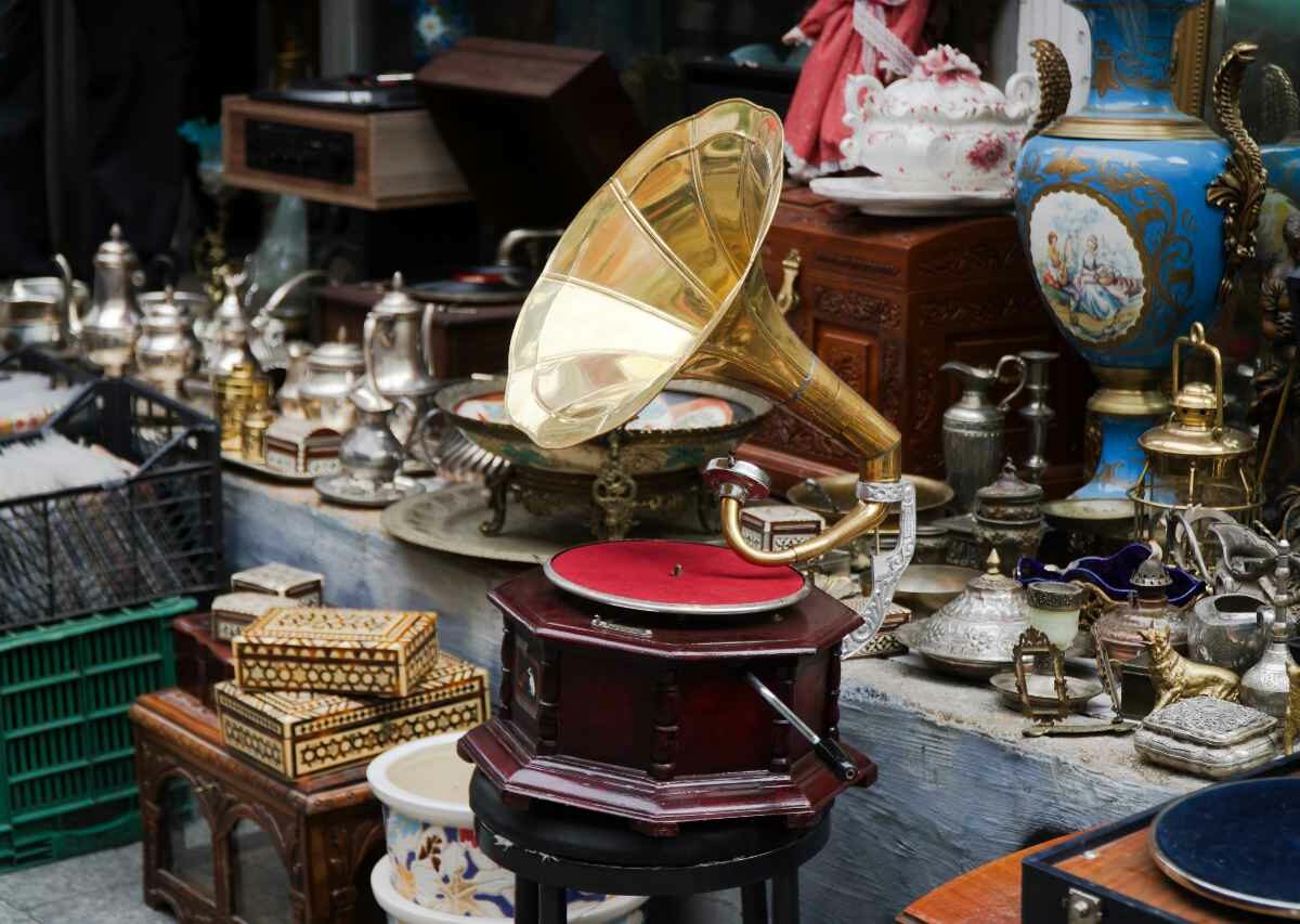 A vintage gramophone surrounded by other antiques