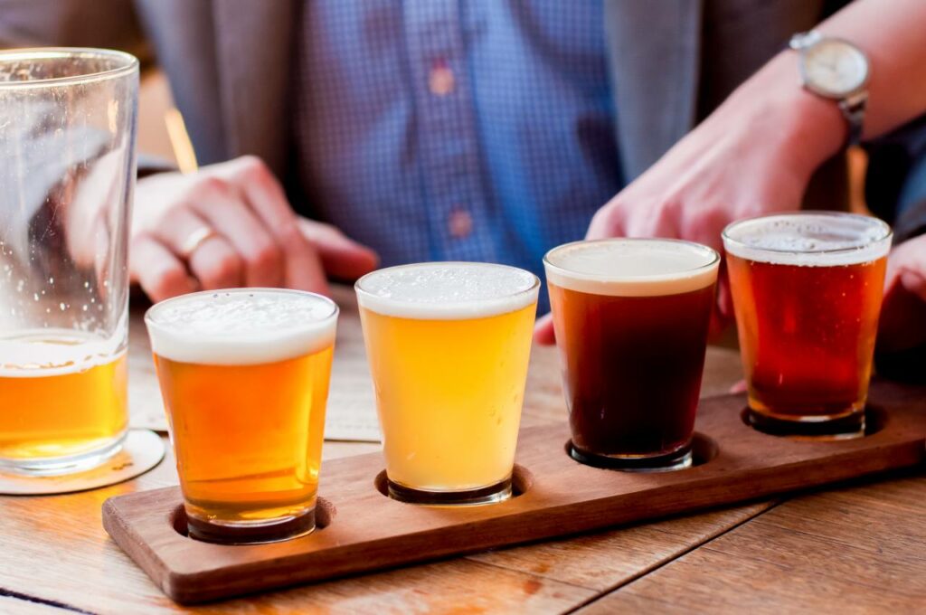 A flight of beers sits ready to drink