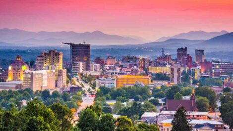 An aerial shot of downtown Asheville, NC at dusk