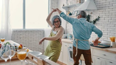 A senior couple having fun baking in the kitchen