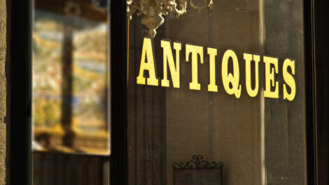 A sign to a store that says “antiques”