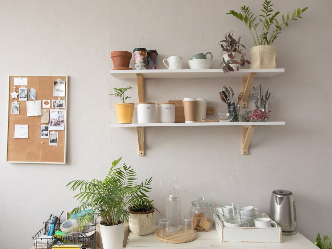 Floating shelves used to hold up plants and kitchenware.